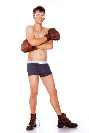 Portrait of plump naked young man posing in studio in boxing glowesの写真素材