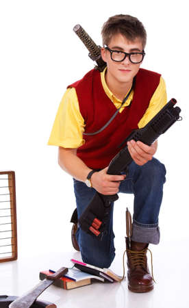 Portrait of tipical nerd posing in studio with lot of danger gunsの写真素材