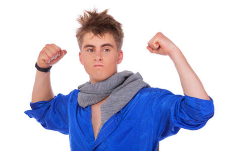 Portrait of tipical nerd posing in studio showing his powerの写真素材