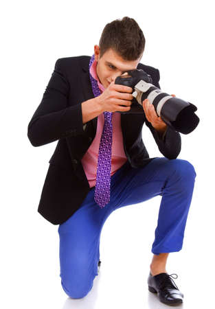 A handsome photograph is taking a picture while kneelingの写真素材