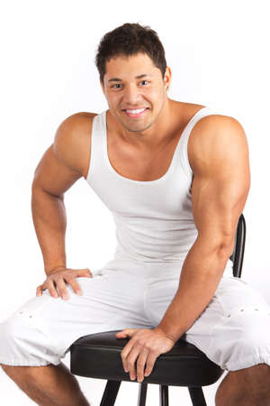 Happy young man sitting on the chairの写真素材