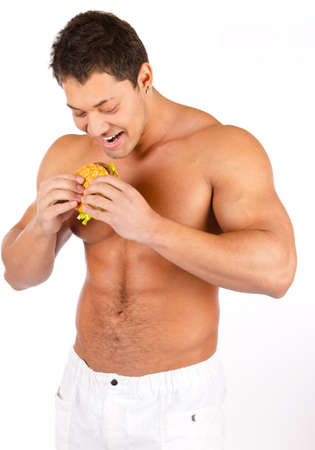 Muscular male body with tasty burgerの写真素材