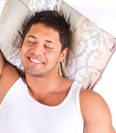 young man relaxing on pillowの写真素材