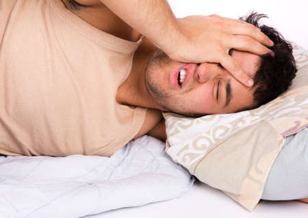 Young man  in bed , trying to sleepの写真素材
