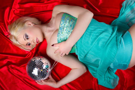Sexy blonde holding shining sphere の写真素材