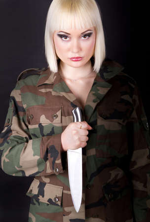 Shot of a beautiful girl holding knifeの写真素材