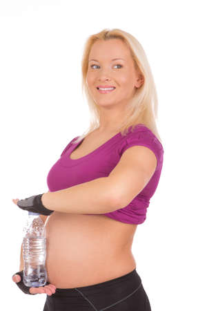 Pregnant Fitness Woman with bottle of waterの写真素材