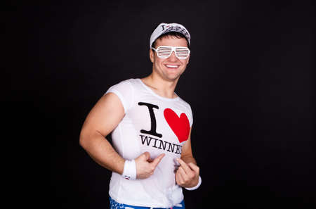 Portrait of an excited young guy soccer fanの写真素材