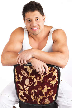 Happy young man sitting on the chairの写真素材