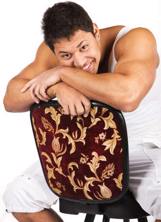 Happy young man sitting on the chairの写真素材