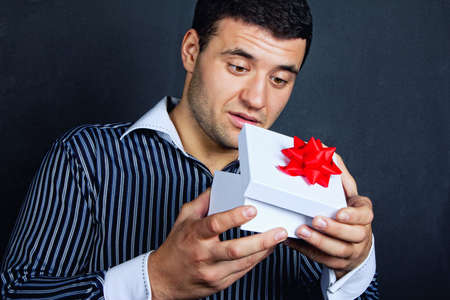 Surprised  man opening big gift box の写真素材