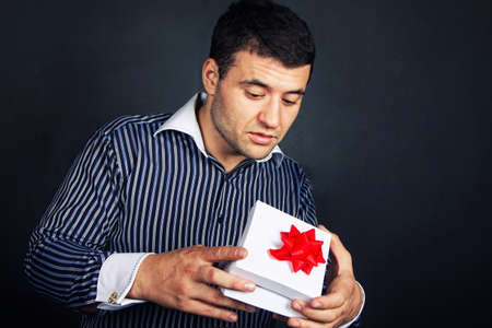 Surprised  man opening big gift box の写真素材