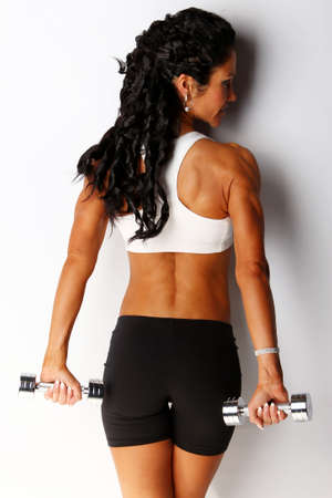 Image of female posing with metal dumbellsの写真素材