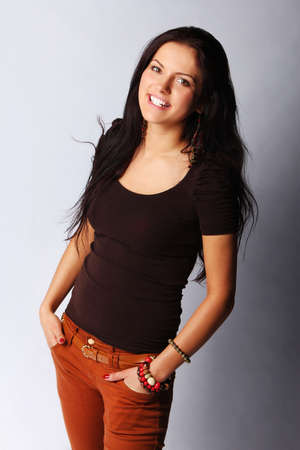 Image of happy attractive female smiling, isolated on greyの写真素材