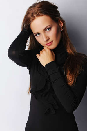 Portrait of young brunette female, isolated on greyの写真素材