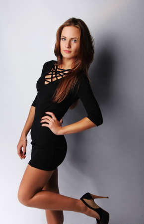 Image of young brunette female posing, isolated on greyの写真素材