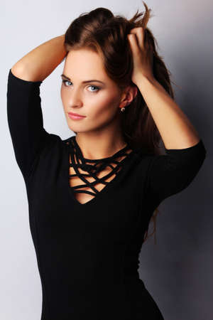 Portrait of young brunette female, isolated on greyの写真素材