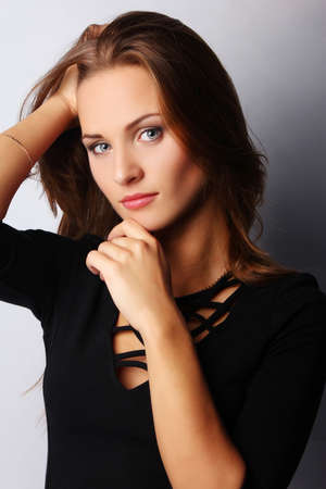 Portrait of young brunette female, isolated on greyの写真素材