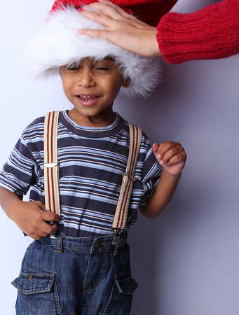 Profile of an adorable African American baby in a Santa Hatの写真素材