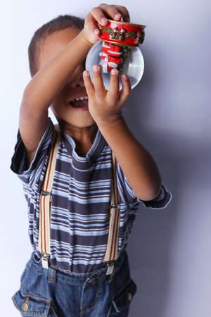 Cute happy 3 year old American-African boy playing with christmas ballの写真素材