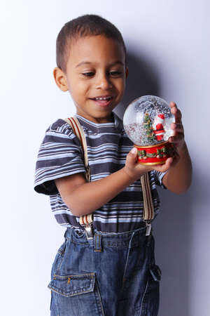 Cute happy 3 year old American-African boy playing with christmas ballの写真素材