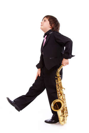 Portrait of young sexy musician posing in studio with saxophoneの写真素材