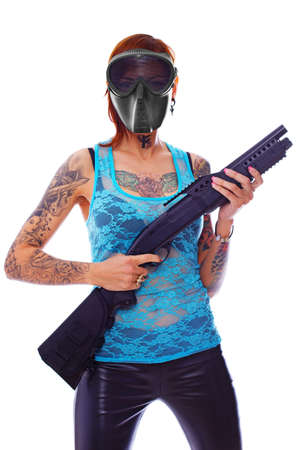 A young girl with multiple tattoos and a shotgunの写真素材