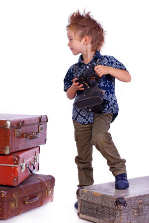 Portrait of young traveler posing in studio with cameraの写真素材