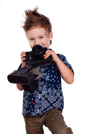 Portrait of young man posing in studio with cameraの写真素材