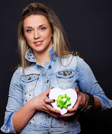 Portrait of sexy woman posing in studio with presentの写真素材
