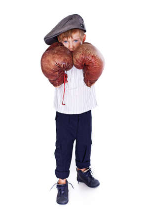 Portrait of handsome kid posing in studio with boxing glovesの写真素材