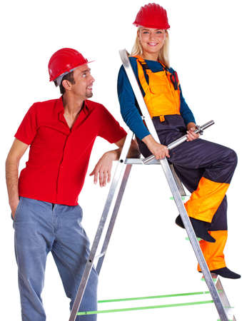 Portrait of couple posing in studio on ladderの写真素材
