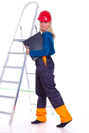 Portrait of sexy woman posing in studio on ladderの写真素材
