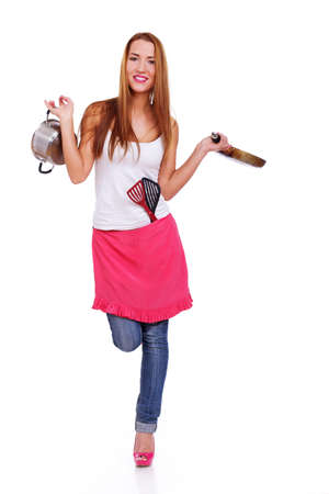 Portrait of sexy woman posing in studio with kitchen accessoriesの写真素材