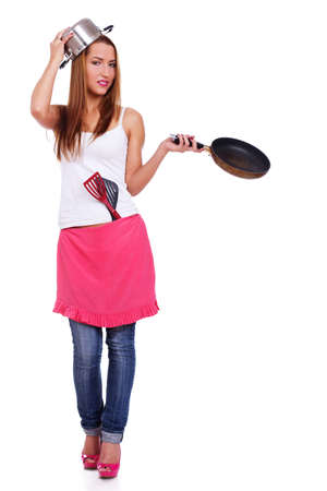 Portrait of sexy woman posing in studio with kitchen accessoriesの写真素材