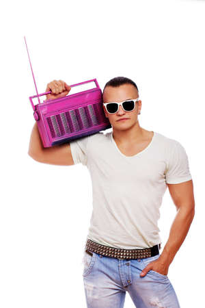 Portrait of muscle man posing in studio with radioの写真素材