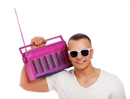 Portrait of muscle man posing in studio with radioの写真素材