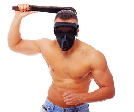 Portrait of danger man in mask posing in studioの写真素材