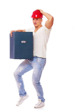 Portrait of sexy worker posing in studio in red helmet with box of thingsの写真素材