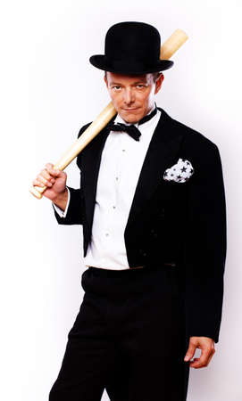 Portrait of man posing in studio in official clothes with batの写真素材