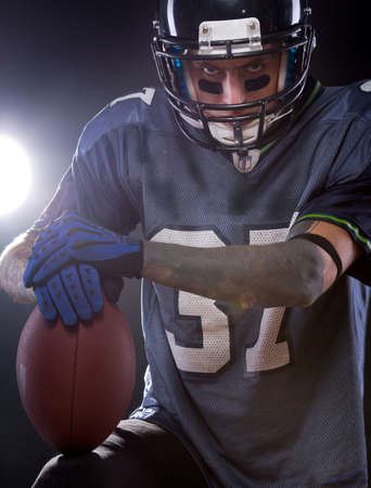 An American football quarterback is prepared for the game