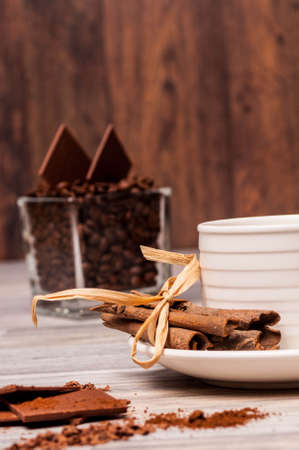 Tied cinnamon sticks with coffee beans and chocolate