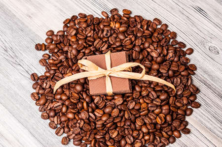 Pile of coffee beans with chocolate on the top of itの写真素材