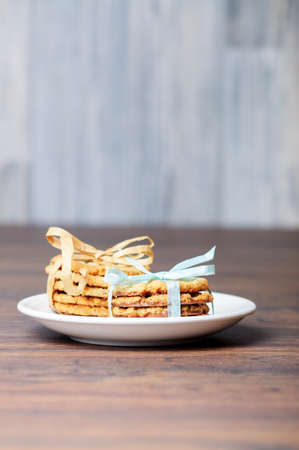 A plate with two stacks of cookies with bowsの写真素材