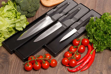 Different size knives and vegetables