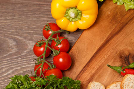 Vegetables and bread on woodの写真素材