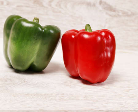 Two bell peppers on light woodの写真素材