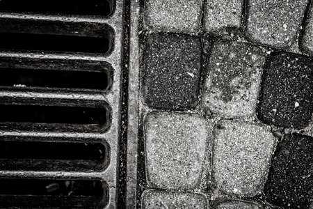 Storm drain closeup in black and whiteの写真素材