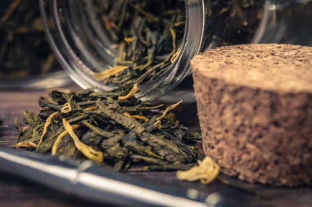 A cork and green tea leavesの写真素材