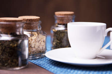 Three little jars and a white cupの写真素材